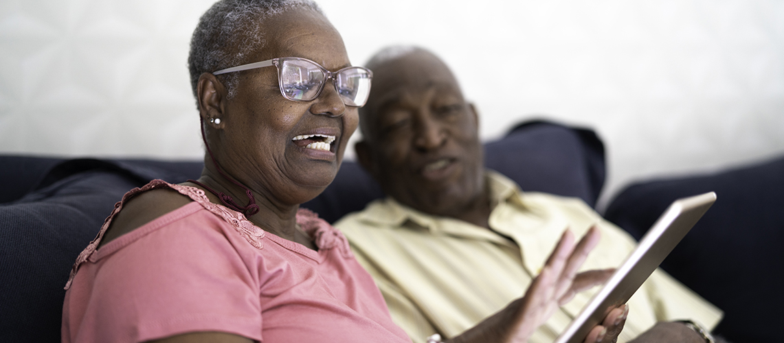 A senior couple using a tablet.